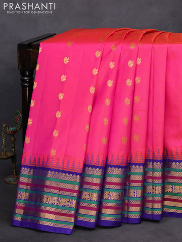 Pure gadwal silk saree dual shade of pinkish orange and blue with zari woven buttas and temple design zari border