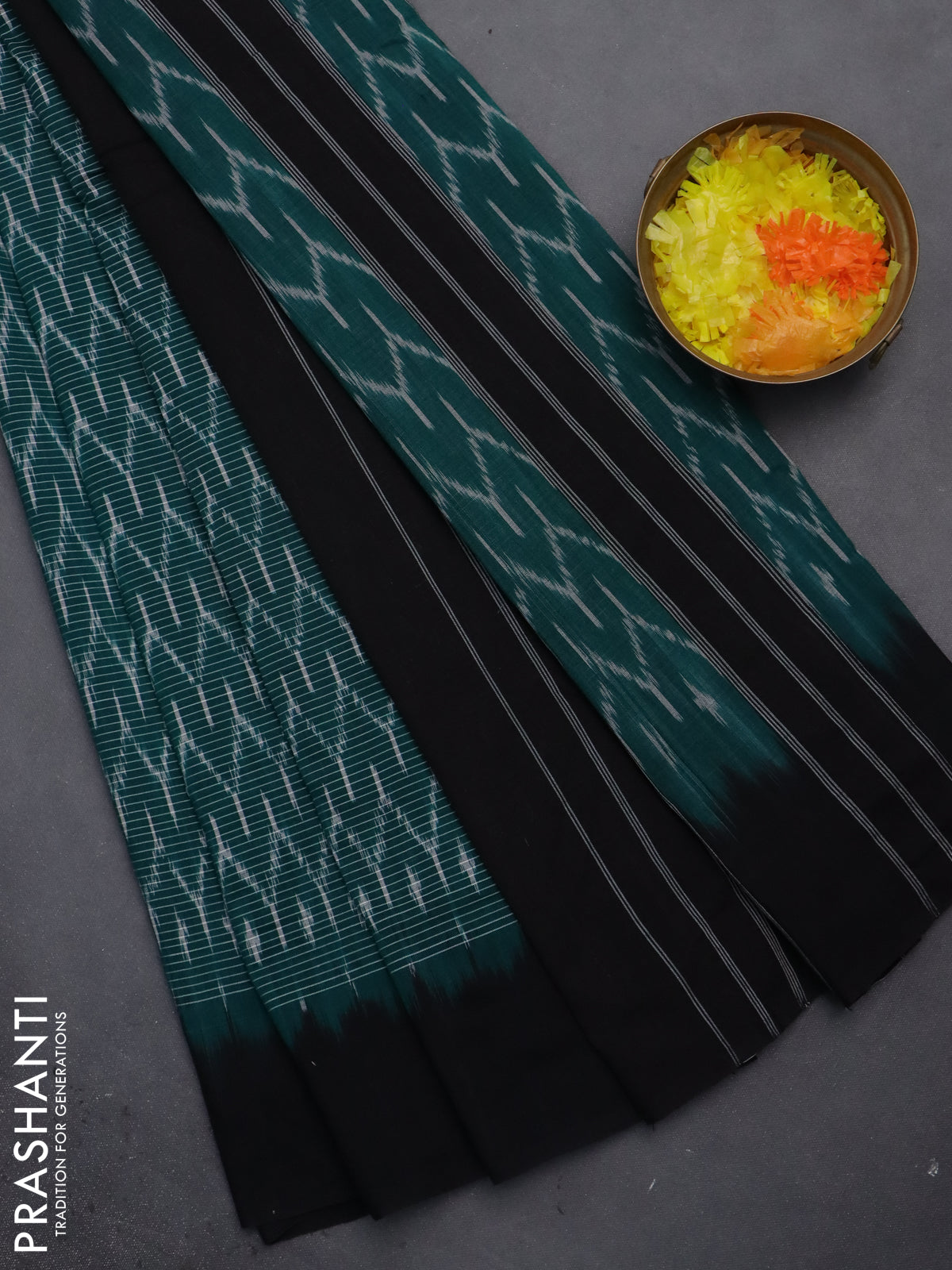 Ikat cotton saree teal green and black with allover ikat weaves and simple border