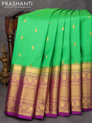 Pure gadwal silk saree light green and deep purple with zari woven buttas and long zari woven floral design zari border